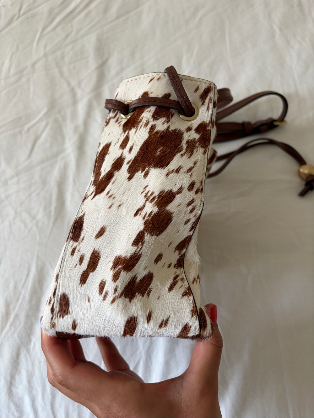 The Mini Drawstring Crossbody Bucket Bag Cow Print - Picture 4 of 11